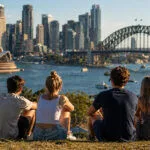 Sydney manzarasına bakan genç Avustralyalıları temsil eden haber görseli.